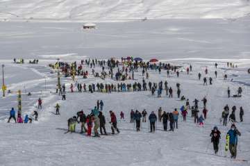 Indian tourists and locals ski on a slope in Gulmarg, northwest of Srinagar