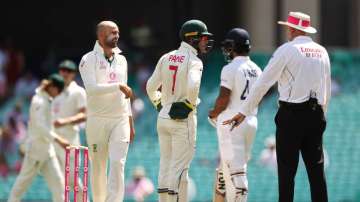 Tim Paine and Nathan Lyon of Australia questions Umpire Paul Wilson over a DRS referral against Cheteshwar Pujara of India during day three of the 3rd Test match in the series between Australia and India at Sydney Cricket Ground on January 09, 2021 in Sydney, Australia.