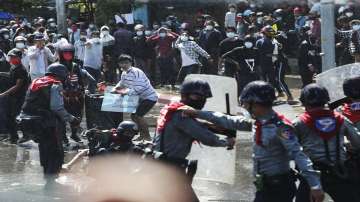 Protesters run after police fire warning-shots and use water cannons to disperse them during a protest in Mandalay, Myanmar.