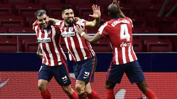 Atletico Madrid's Luis Suarez, center, celebrates with teammates after scoring during a La Liga soccer match between Atletico Madrid and Celta at the Wanda Metropolitano stadium in Madrid, Spain, Monday, Feb. 8
