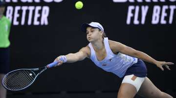 Australia's Ash Barty hits a forehand return to Russia's Ekaterina Alexandrova during their third round match at the Australian Open tennis championship in Melbourne, Australia, Saturday, Feb. 13