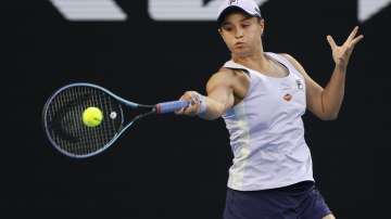 Australia's Ashleigh Barty makes a forehand return to Montenegrin's Danke Kovinic during their first round match at the Australian Open tennis championship in Melbourne, Australia, Tuesday, Feb. 9