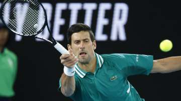 Serbia's Novak Djokovic makes a forehand return to France's Jeremy Chardy during their first round match at the Australian Open tennis championship in Melbourne, Australia, Monday, Feb. 8