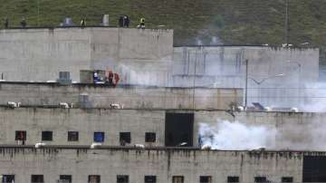 Tear gas rises from parts of Turi jail where an inmate riot broke out in Cuenca, Ecuador