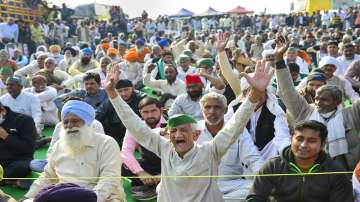 Farmers raise slogans during the ongoing protest against the new farm laws, at Ghazipur Border in New Delhi.