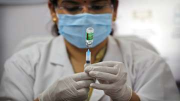 A health worker prepares to administer a COVID-19 vaccine at a hospital in New Delhi.