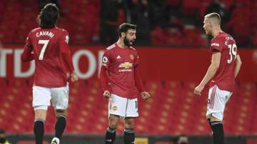 Manchester United's Bruno Fernandes, centre, celebrates after scoring his side's second goal during an English Premier League soccer match between Manchester United and Everton at the Old Trafford stadium in Manchester, England, Saturday Feb. 6
