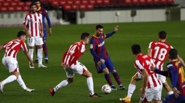 Barcelona's Lionel Messi, center, plays the ball during the Spanish La Liga soccer match between FC Barcelona and Athletic Bilbao at the Camp Nou stadium in Barcelona, Spain, Sunday, Jan. 31
