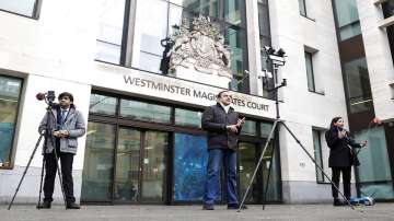 Journalists report the verdict to allow the extradition of Nirav Modi, outside Westminster Magistrates Court, in London.