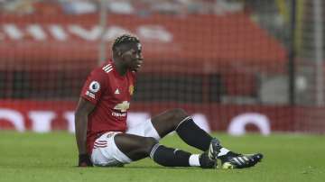 Manchester United's Paul Pogba sits on the ground after getting injured during an English Premier League soccer match between Manchester United and Everton at the Old Trafford stadium in Manchester, England, Saturday Feb. 6