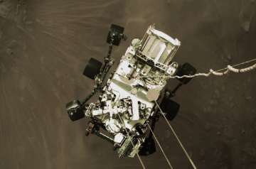 NASA shows the Perseverance rover lowered towards the surface of Mars during its powered descent.