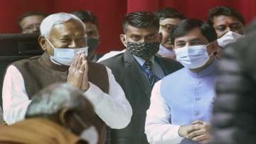 Chief Minister Nitish Kumar congratulates Syed Shahnawaz Hussain after taking oath during the swearing-in ceremony for the cabinet expansion of coalition government of NDA at Raj Bhawan, in Patna.