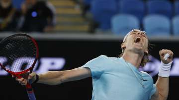 Canada's Denis Shapovalov reacts after defeating Italy's Jannik Sinner during the first round match at the Australian Open tennis championship in Melbourne, Australia, Monday, Feb. 8