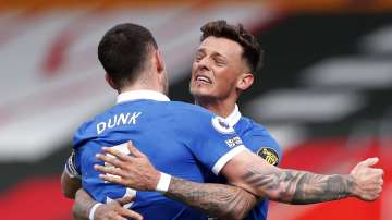 Brighton's Lewis Dunk, left and Ben White celebrate at the end of an English Premier League soccer match between Southampton and Brighton after defeating Southampton at the St Mary's Stadium in Southampton, England, Sunday March 14