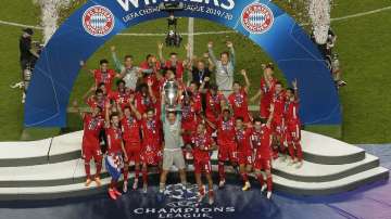 In this file photo dated Sunday, Aug. 23, 2020, Bayern's goalkeeper Manuel Neuer lifts the trophy after the Champions League final soccer match between Paris Saint-Germain and Bayern Munich