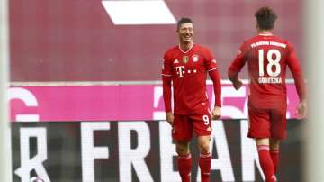 Bayern's Robert Lewandowski, left, celebrates with Bayern's Leon Goretzka after scoring his sides third goal during the German Bundesliga soccer match between FC Bayern Munich and VfB Stuttgart in Munich, Germany, Saturday, March 20
