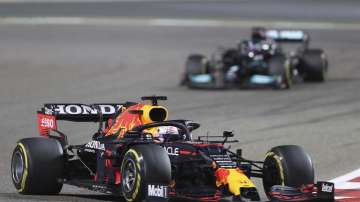 Red Bull driver Max Verstappen of the Netherlands steers his car followed by Mercedes driver Lewis Hamilton of Britain during the Bahrain Formula One Grand Prix at the Bahrain International Circuit in Sakhir, Bahrain, Sunday, March 28