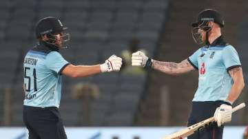 England batsman Ben Stokes celebrates his half century with Jonny Bairstow (l) during the 2nd One Day International between India and England at MCA Stadium on March 26