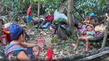 In this photo released by the Free Burma Rangers, Karen villagers gather in the forests as they hide from military airstrikes in the Deh Bu Noh area of the Papun district, north Karen state, Myanmar, on March 28.
 
