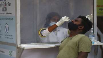 A health worker takes a nasal swab sample at a COVID-19 testing center in India.