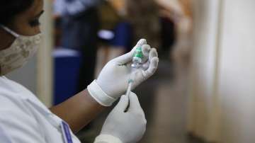 A nurse prepares to administer a shot of the COVID-19 vaccine.