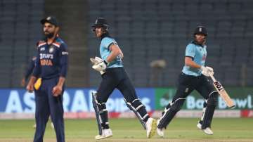 England batsmen Ben Stokes (l) and Jonathan Bairstow pick up runs during their partnership as India captain Virat Kohli reacts during the 2nd One Day International between India and England at MCA Stadium on March 26