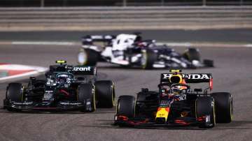 Sergio Perez of Mexico driving the (11) Red Bull Racing RB16B Honda and Sebastian Vettel of Germany driving the (5) Aston Martin AMR21 Mercedes compete for position on track during the F1 Grand Prix of Bahrain at Bahrain International Circuit on March 28, 2021 in Bahrain, Bahrain