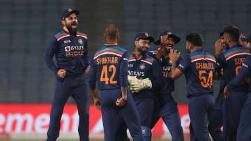 Virat Kohli of India (L) celebrates the wicket of Jos Buttler of England, dismissed by team mate Shardul Thakur during the 3rd One Day International match between India and England at MCA Stadium on March 28