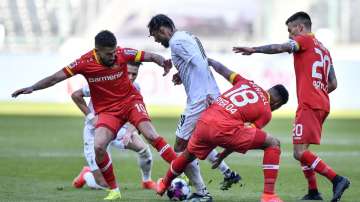 Leverkusen's Kerem Demirbay, Moenchengladbach's Valentino Lazaro, Leverkusen's Wendell and Leverkusen's Charles Aranguiz, from left, challenge for the ball during the German Bundesliga soccer match between Borussia Moenchengladbach and Bayer Leverkusen in Moenchengladbach, Germany, Saturday, March 6