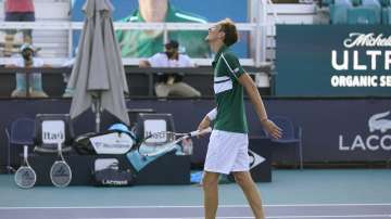 Daniil Medvedev, of Russia, walks gingerly to the net after defeating Alexei Popyrin, of Australia, during the Miami Open tennis tournament, Sunday, March 28