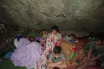 Villagers shelter in the open due to airstrikes in Deh Bu Noh, in Karen state, Myanmar.