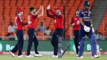 Mark Wood of England celebrates the wicket of KL Rahul of India with (L-R) Eoin Morgan and Jason Roy during the 3rd T20 International between India and England at Narendra Modi Stadium on March 16