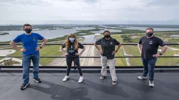 Jared Isaacman, from left to right, Hayley Arceneaux, Sian Proctor and Chris Sembroski pose for a photo, from the SpaceX launch tower at NASA’s Kennedy Space Center at Cape Canaveral, Florida.