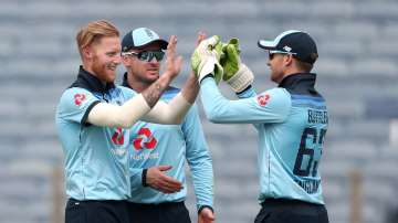 Ben Stokes of England celebrates with Jason Roy and Jos Buttler after dismissing Rohit Sharma of India during 1st One Day International between India and England at MCA Stadium on March 23