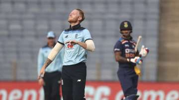 England's Ben Stokes, front, celebrates the dismissal of India's Shikhar Dhawan, right, during the first One Day International cricket match between India and England at Maharashtra Cricket Association Stadium in Pune, India, Tuesday, March 23