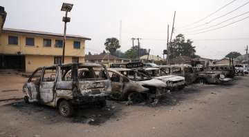 Burned vehicles are parked outside the police command headquarters in Owerri, Nigeria, on Monday, April 5, 2021