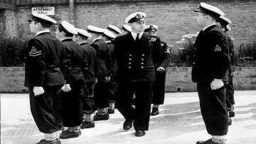 In this July 31, 1947 file photo, Lieut. Philip Mountbatten, as he was then called, center, inspects his men at the Petty Officers' Training Center at Corsham, England. 