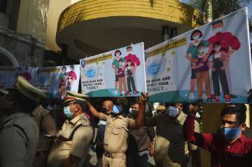 Police officers hold banners during an awareness drive for a coronavirus prevention drive in Hyderabad