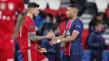 PSG's Kylian Mbappe, right, greets Bayern's Lucas Hernandez at the end of the Champions League, second leg, quarterfinal soccer match between Paris Saint Germain and Bayern Munich at the Parc des Princes stadium, in Paris, France, Tuesday, April 13