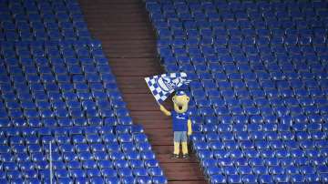 In this Feb.20, 2021 file photo Schalke mascot Erwin waves a team flag from the stands during the German Bundesliga soccer match between FC Schalke 04 and Borussia Dortmund in Gelsenkirchen