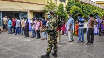 People stand in a queue to cast their votes at a polling station during the 6th phase of West Bengal Assembly Elections at Krishnagar, in Nadia.