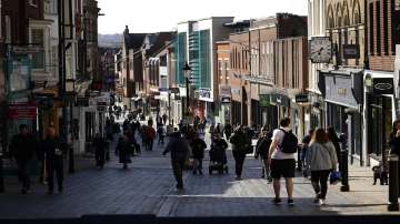 People walk along Peascod Street in Windsor, England, on the first day of the British government lifting some coronavirus restrictions.