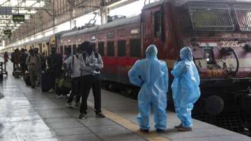 Health workers wait to screen passengers at the Chhatrapati Shivaji Maharaj train Terminus in Mumbai.