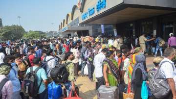 Passengers stand outside the Lokmanya Tilak Terminus to board outstation trains, amid the ongoing spike in COVID-19 cases in Mumbai.