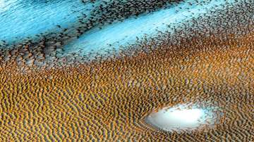 Pictures taken between 2002 and 2004 by Odyssey’s THEMIS imager up this wind-sculpted sea of dark dunes that covers an area as big as Texas at Mars’ northern polar cap. In this enhanced-color image, cooler areas have in bluer tints, while warmer features are depicted in yellows and oranges.