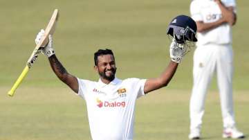 Sri Lanka batsman Dimuth Karunaratne celebrates scoring his double century during the fourth day of the first test cricket match between Sri Lanka and Bangladesh in Pallekele, Sri Lanka, Saturday, April 24