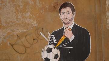 A mural depicting Juventus president Andrea Agnelli making a hole in a football with a knife, appeared in Rome, Thursday, April 22