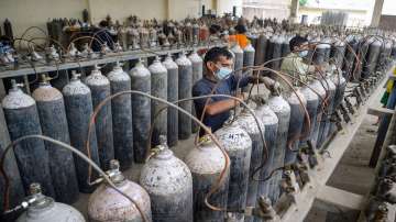 Workers refill cylinders with medical oxygen for supply to hospital for COVID-19 patients at Shakti Oxygen Refill Plant, amid surge in coronavirus cases across the country, in Jalandhar.