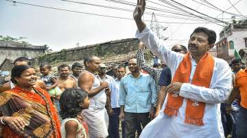 BJP leader Rajib Banerjee during his door-to-door campaign for West Bengal Assembly polls, in Howrah district.