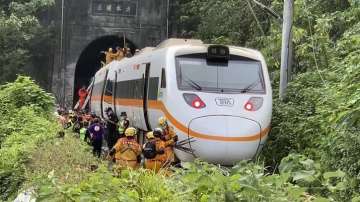 Rescue workers gather near one end of the train involved in a derailment near the Taroko Gorge area in Hualien, Taiwan.